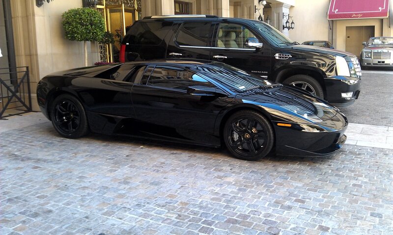 luxury cars parked outside hotel