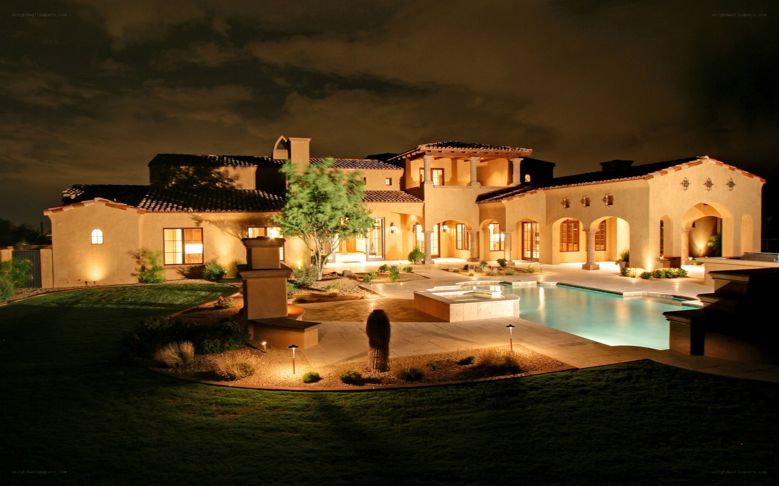 luxury home at night with pool