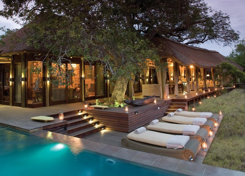 Luxury lodge poolside at dusk