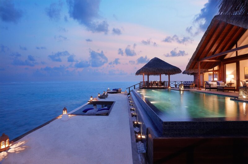 Luxury overwater villa at dusk