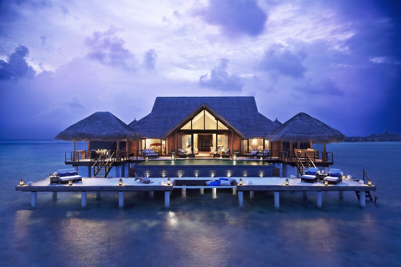 Luxury overwater villa at dusk