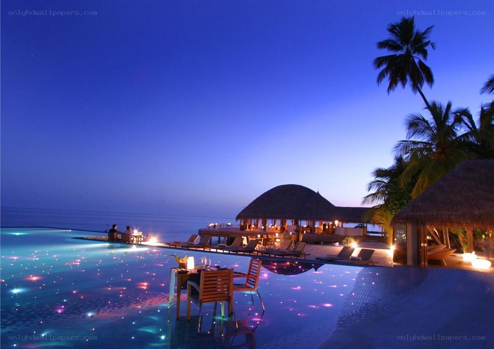 Luxury pool at dusk with ocean view