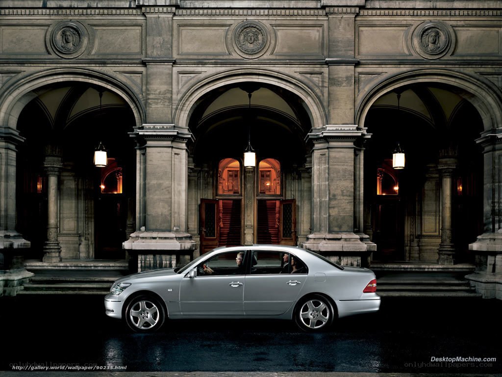 Luxury sedan in front of historic building