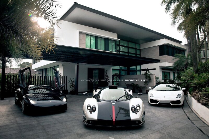 Luxury sports cars at modern home