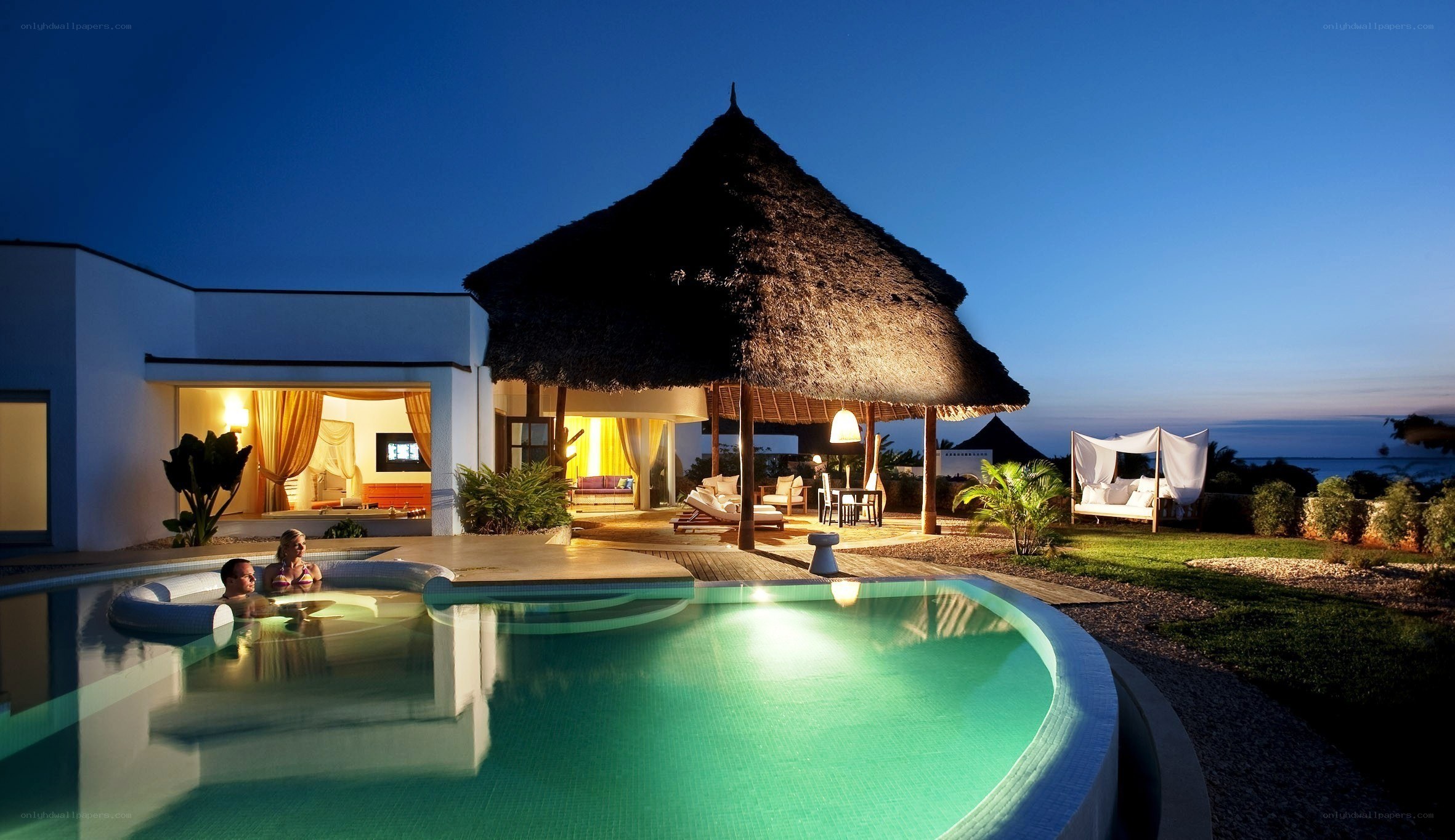 Luxury villa at dusk with pool