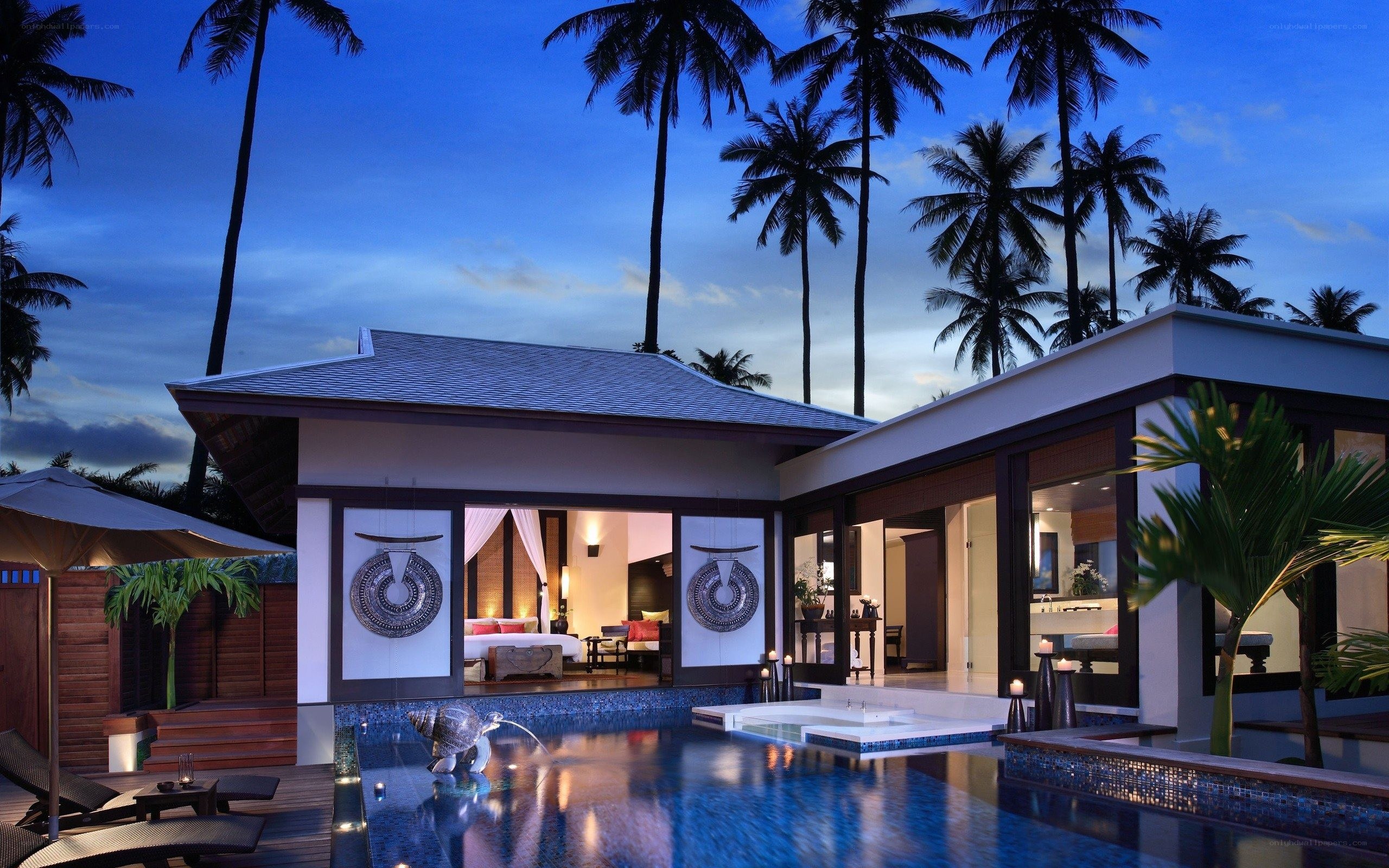 Luxury villa at dusk with pool