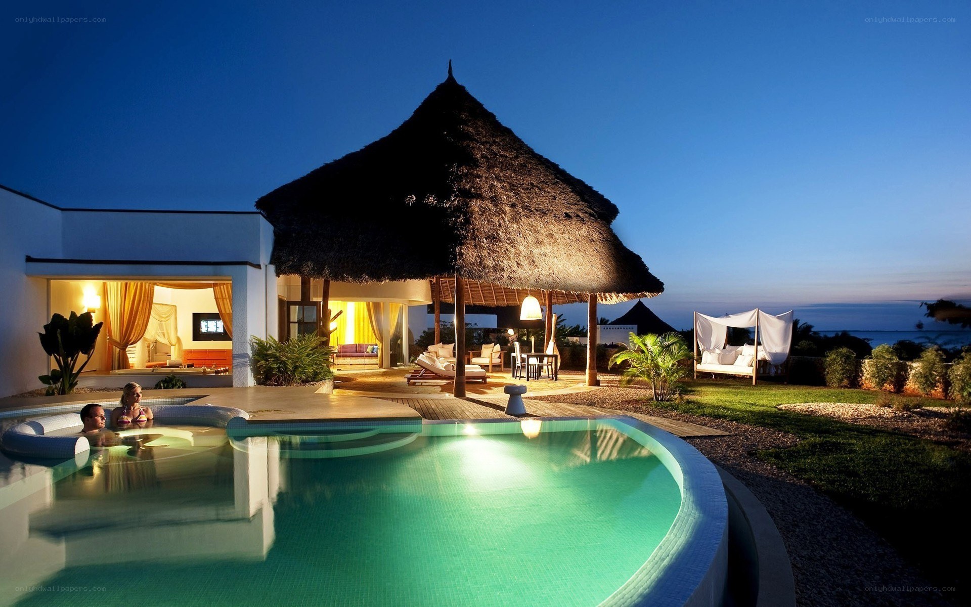 Luxury villa at dusk with pool