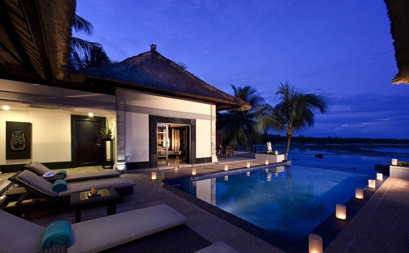 Luxury villa at dusk with pool