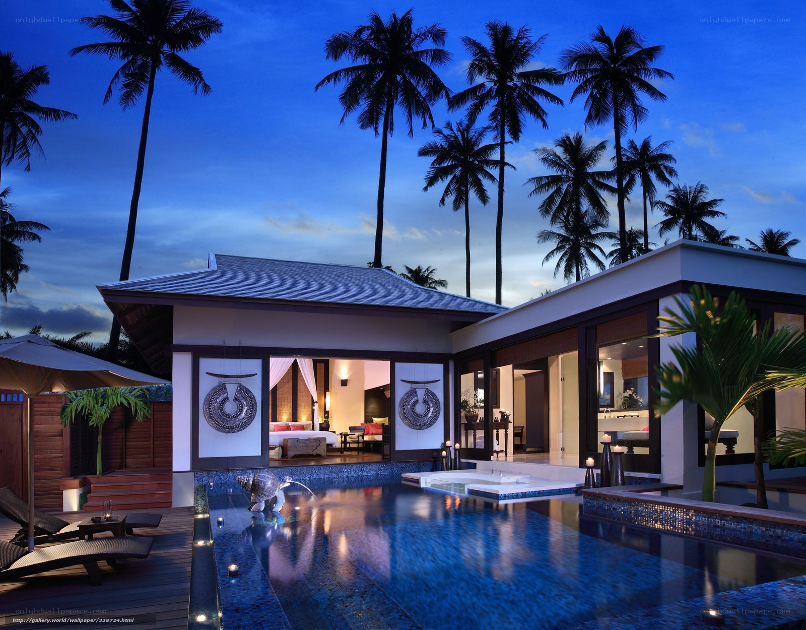 Luxury villa at dusk with pool