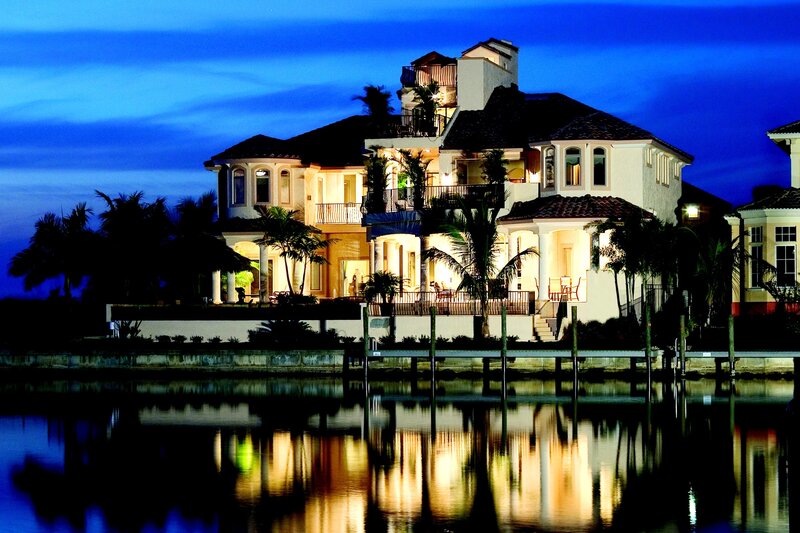 luxury waterfront home at dusk