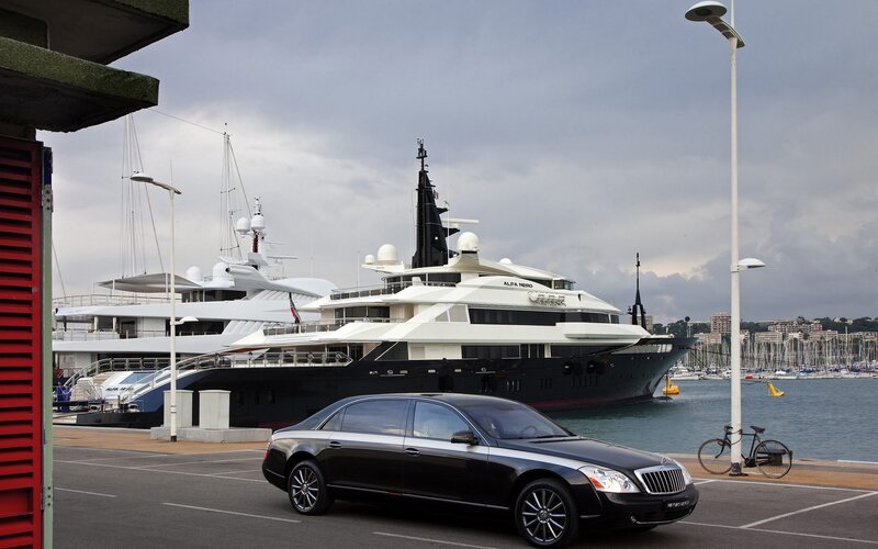 Luxury yacht and car at marina
