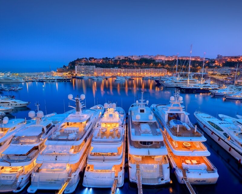 Luxury yachts in a harbor at dusk