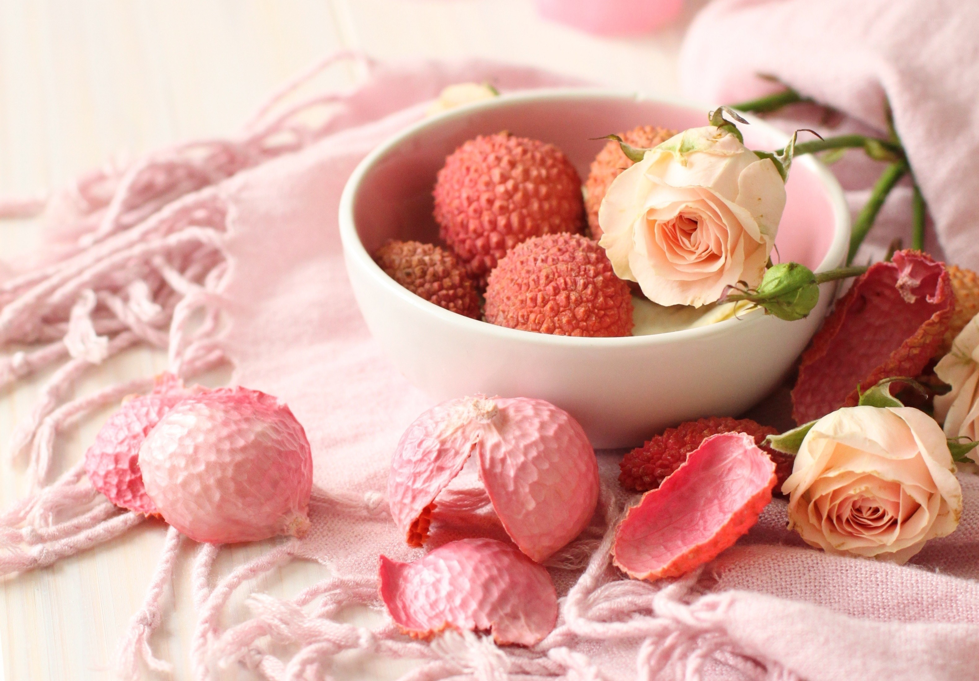 Lychee and roses in a bowl