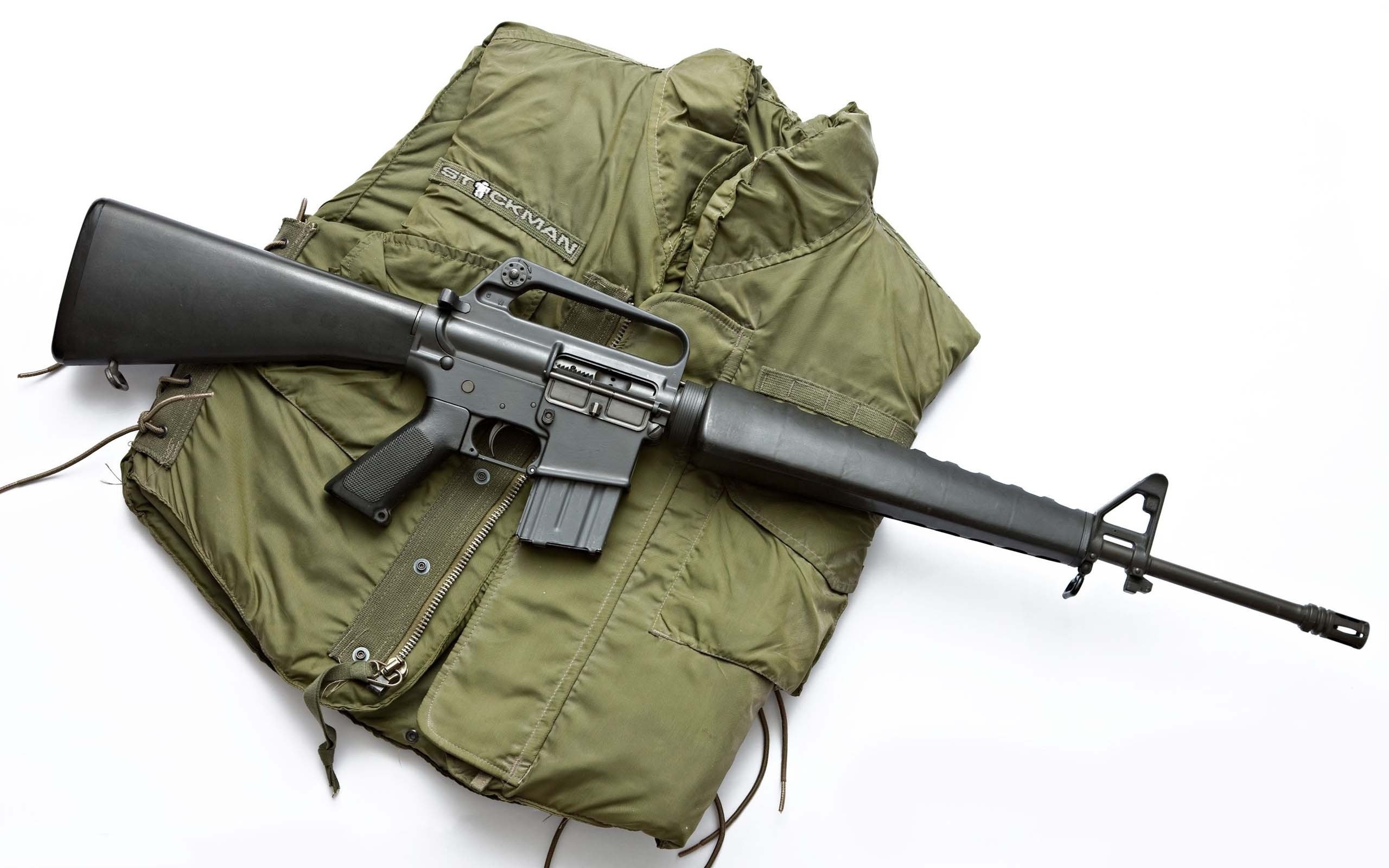 M16 rifle on green vest