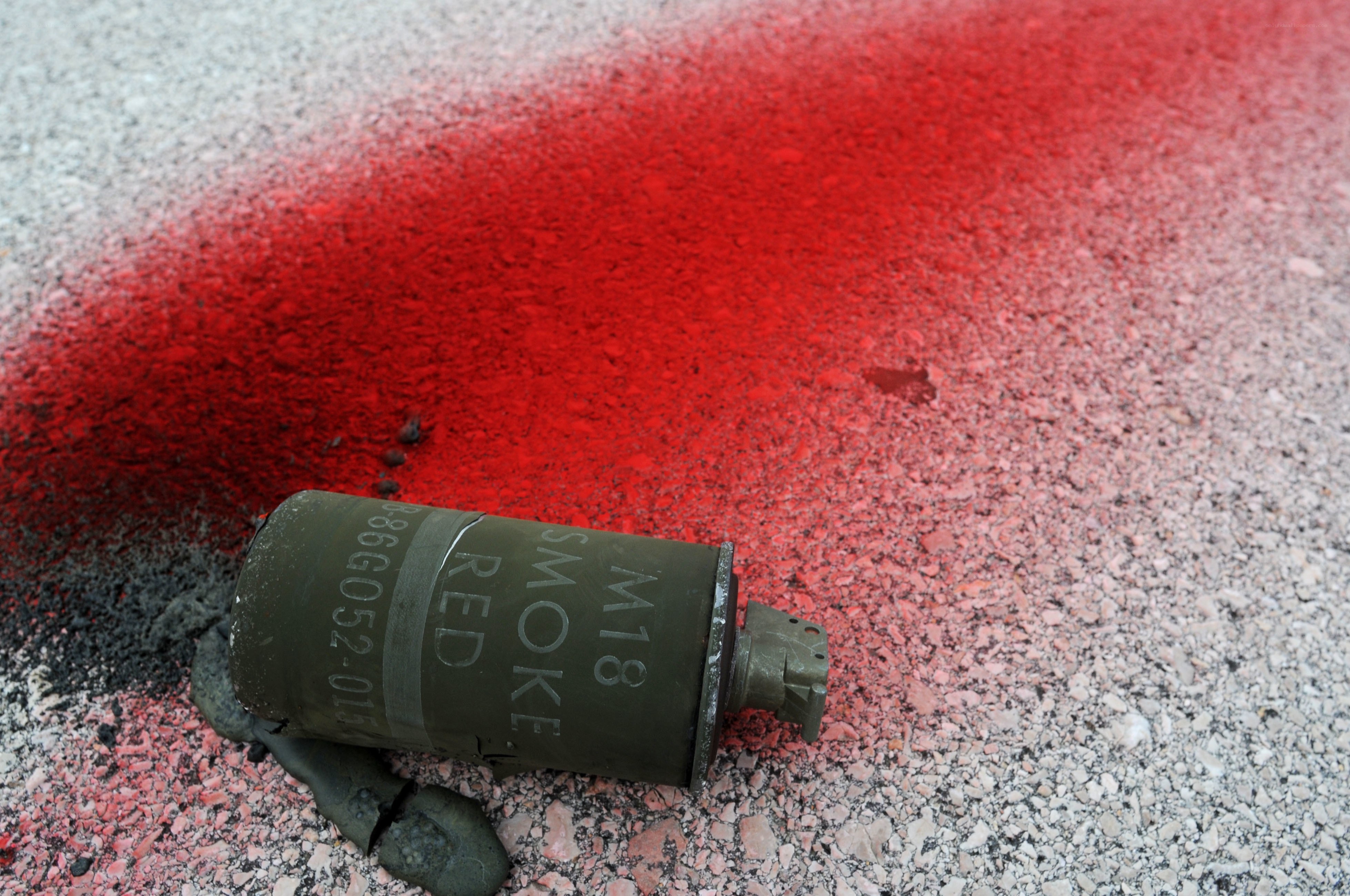 M18 smoke grenade on pavement