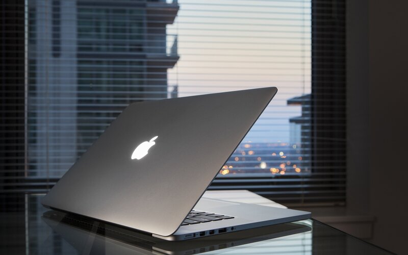 MacBook on glass table