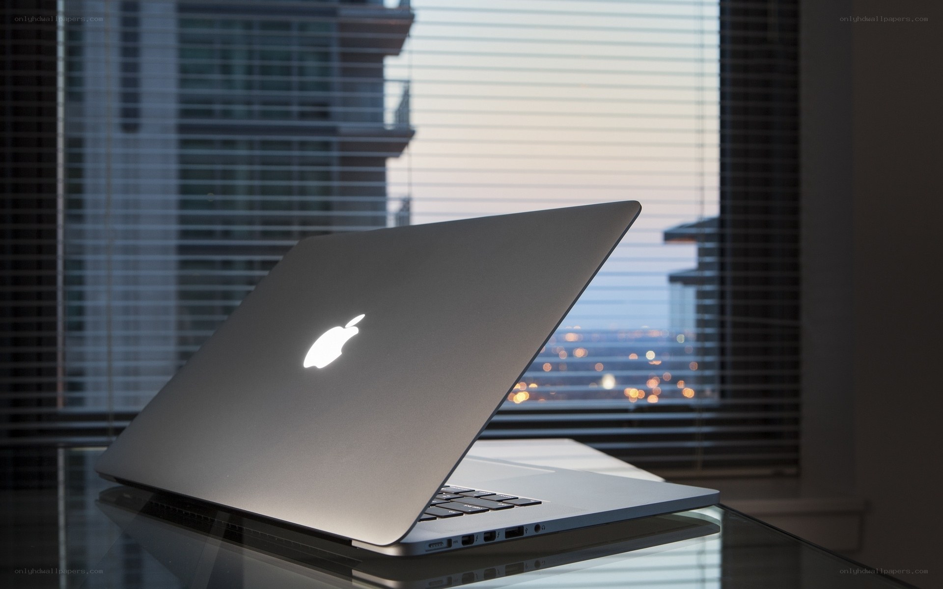 MacBook on glass table
