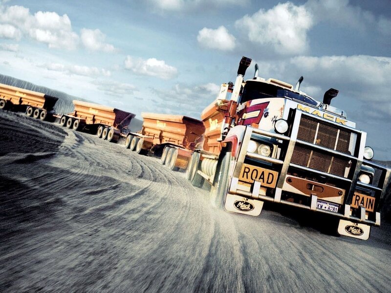 Mack truck convoy on dirt road