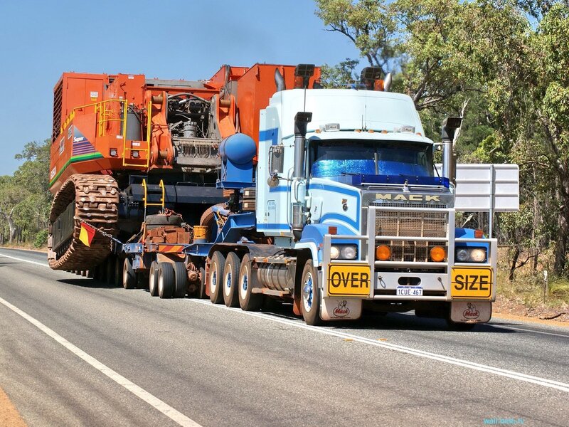 Mack truck hauling heavy machinery