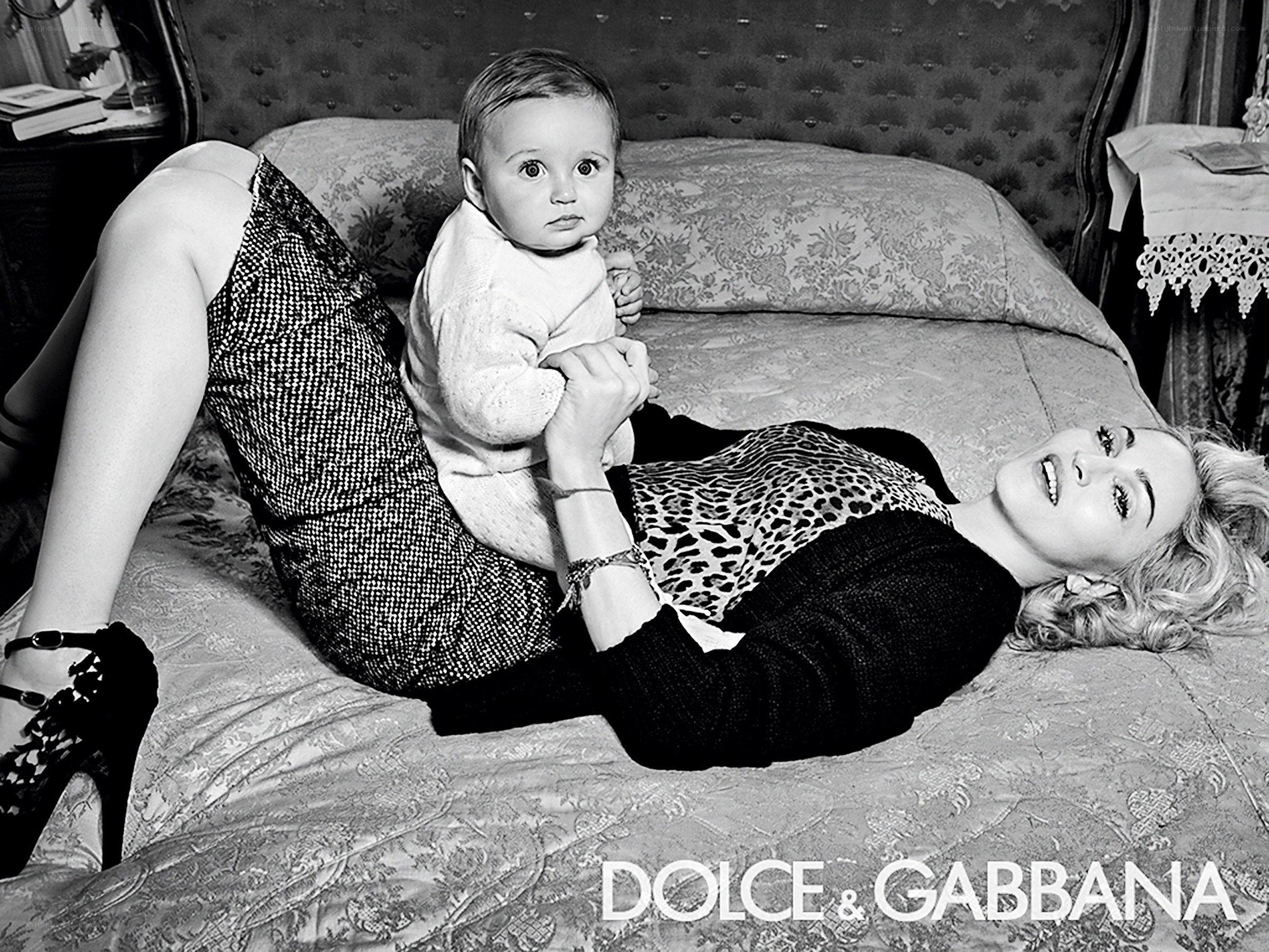 Madonna with baby on bed