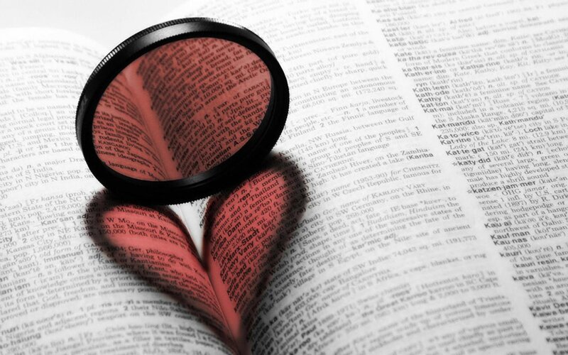 Magnifying Glass on Book — Photograph