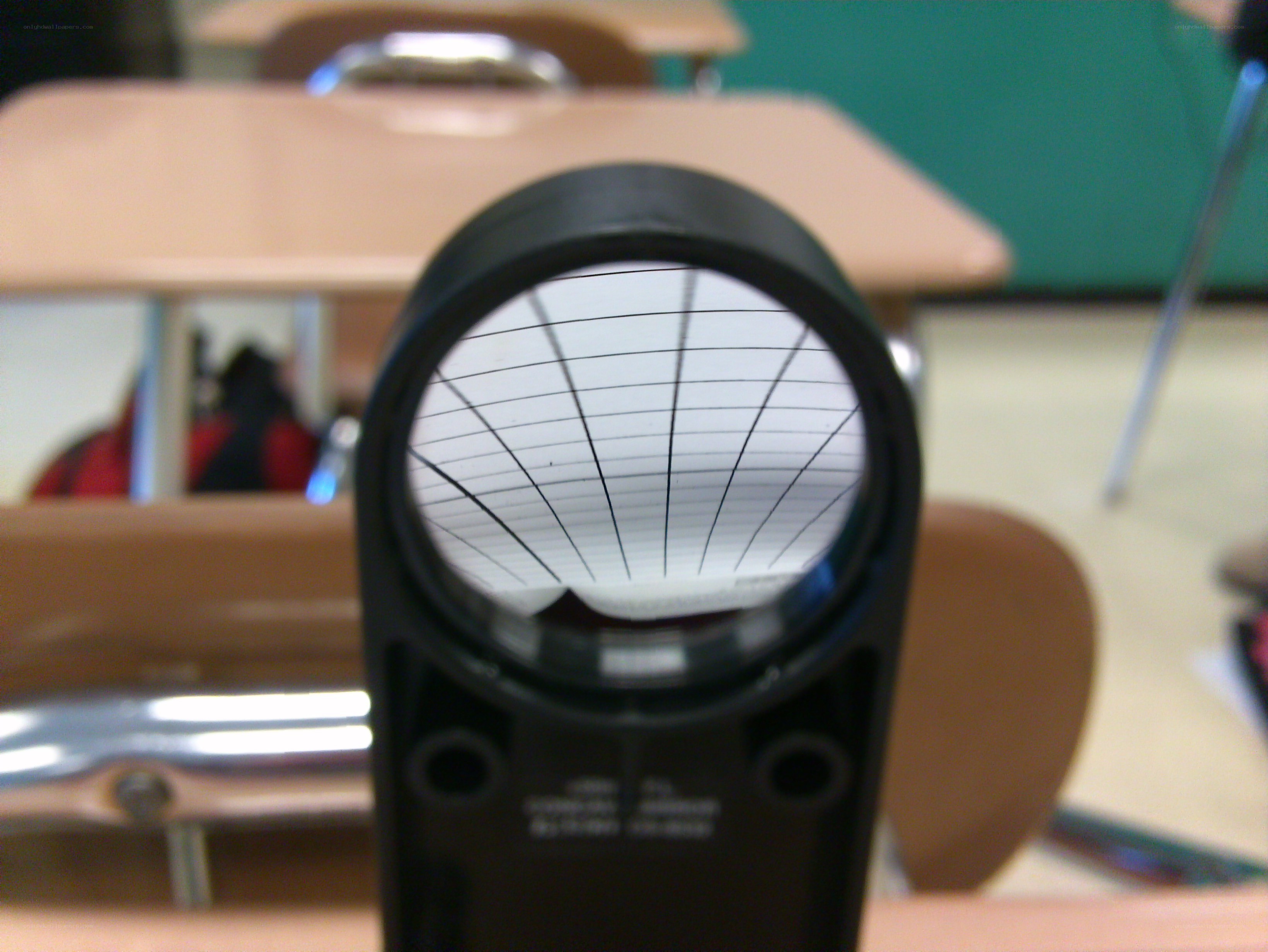 magnifying glass on classroom desk