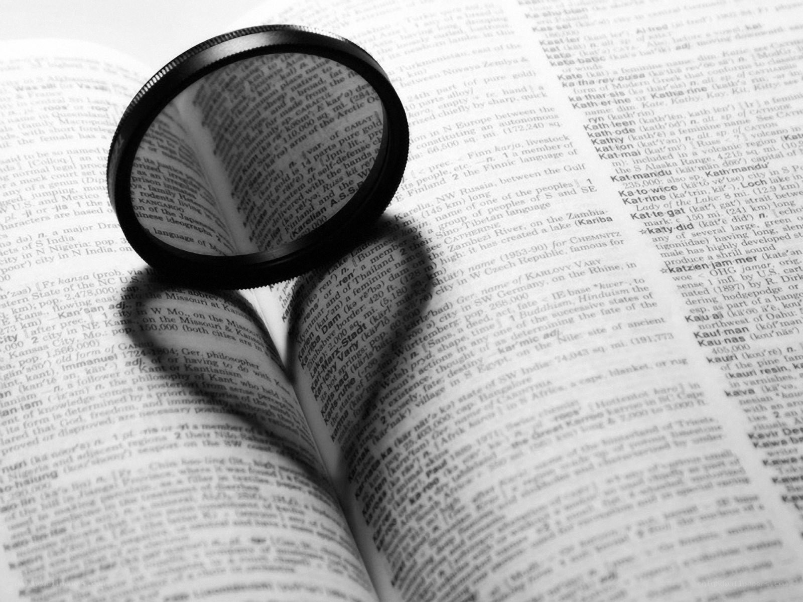 magnifying glass on open book