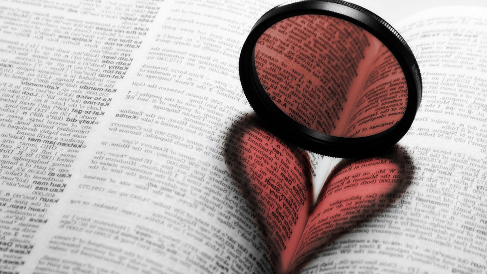magnifying glass on open book