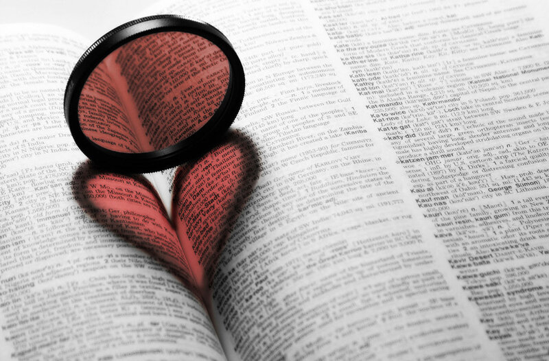magnifying glass over dictionary