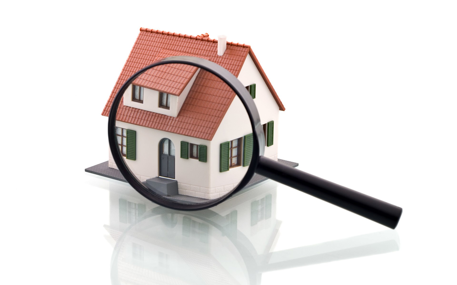 magnifying glass over house model