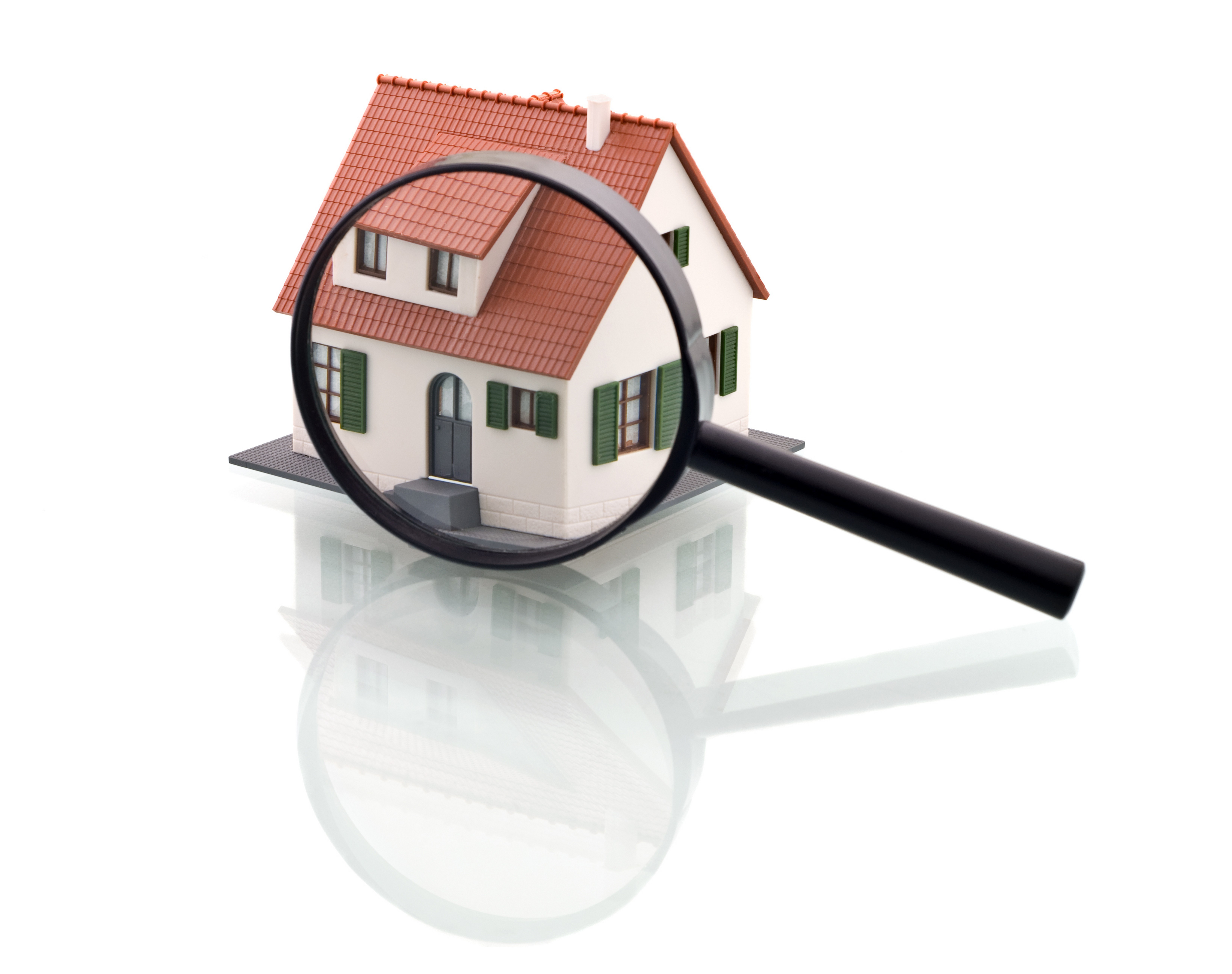 magnifying glass over house model
