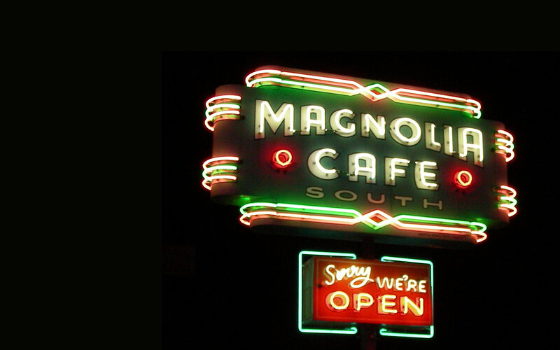 Magnolia Cafe neon sign at night