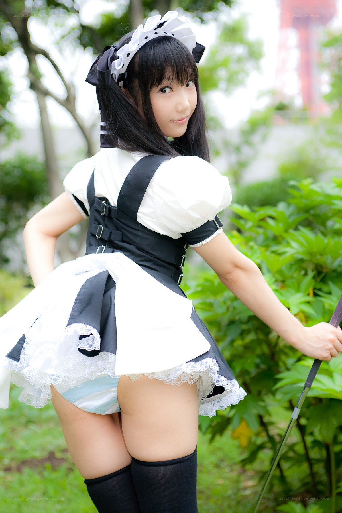 maid cosplayer in garden