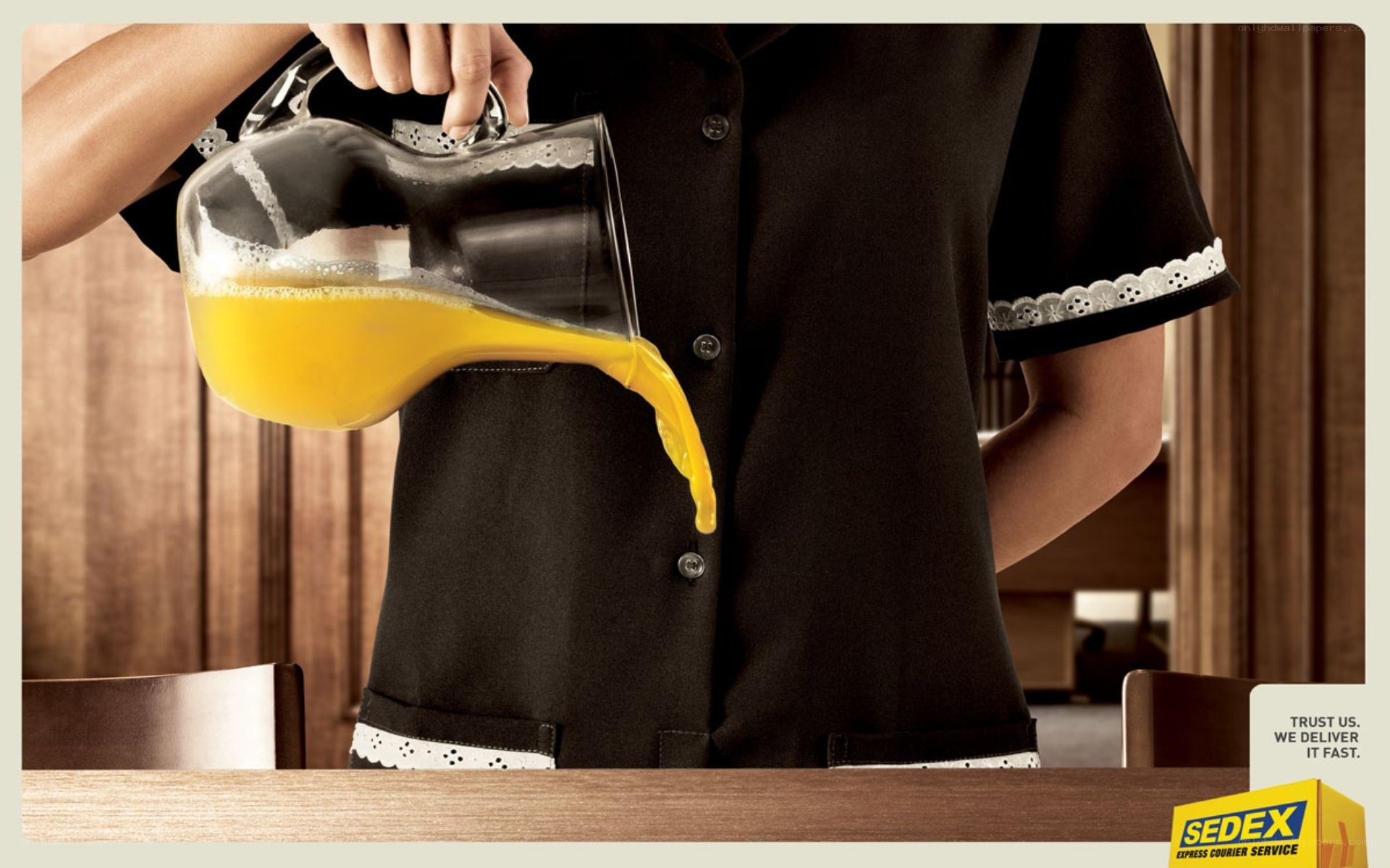 maid pouring orange juice