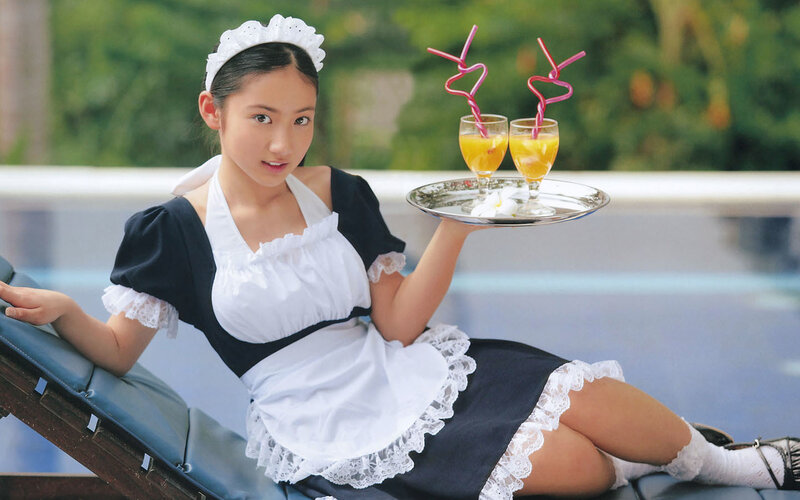 maid serving drinks by pool