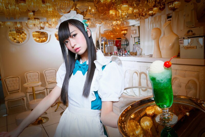maid serving green drink