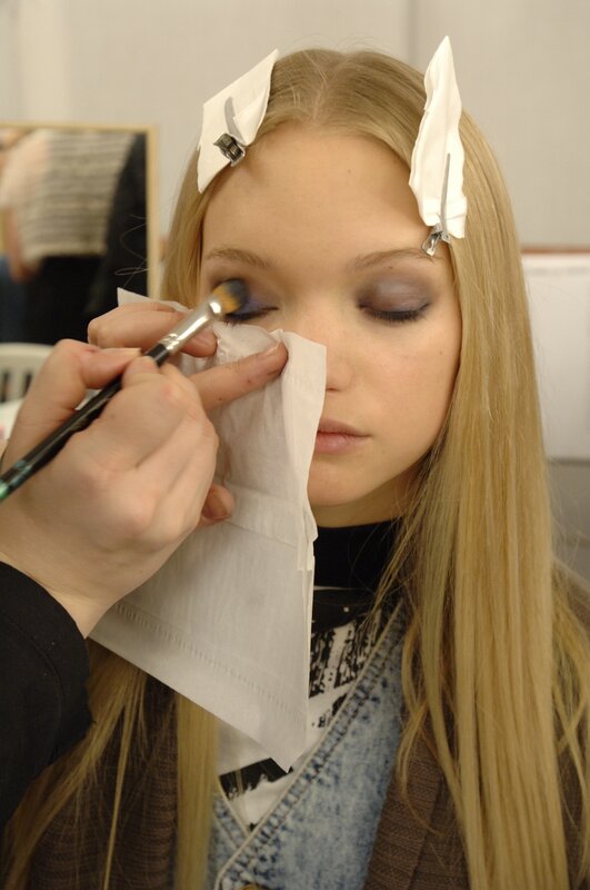 makeup artist applying eyeshadow