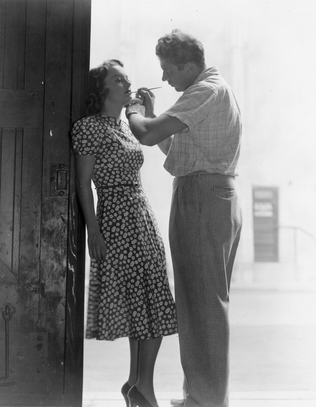 Makeup artist applying makeup to woman