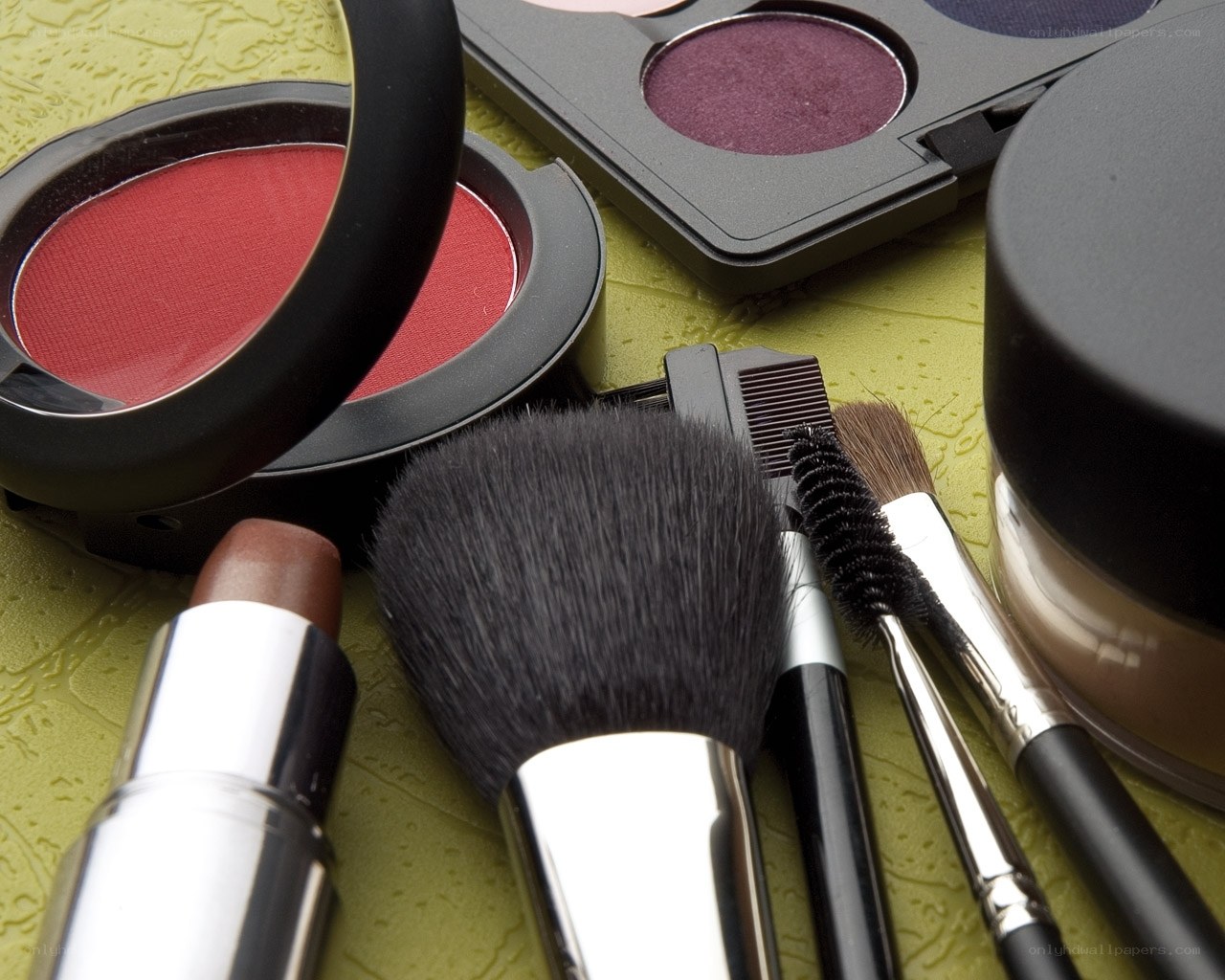 Makeup products on green surface