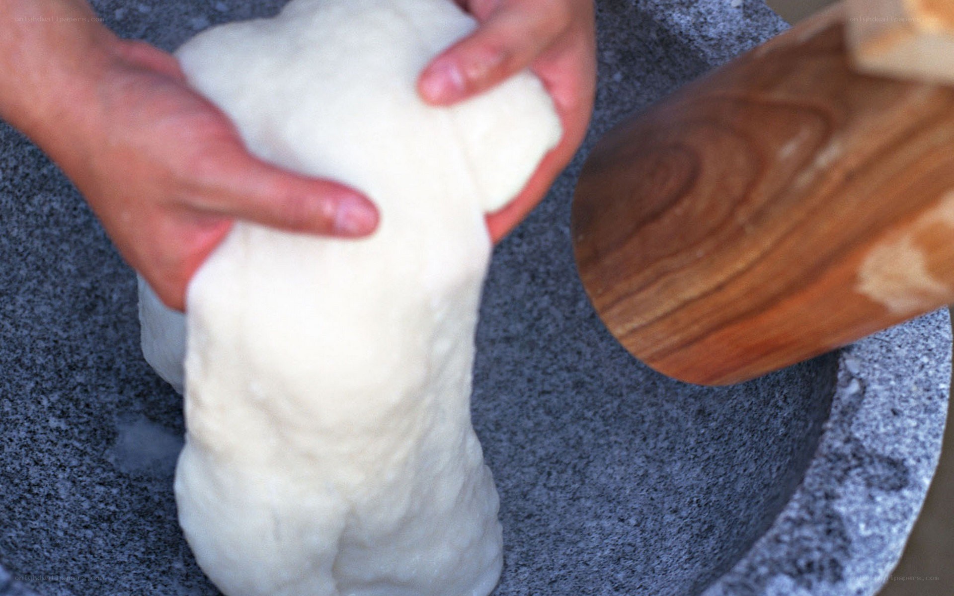 Making mochi with a mortar and pestle