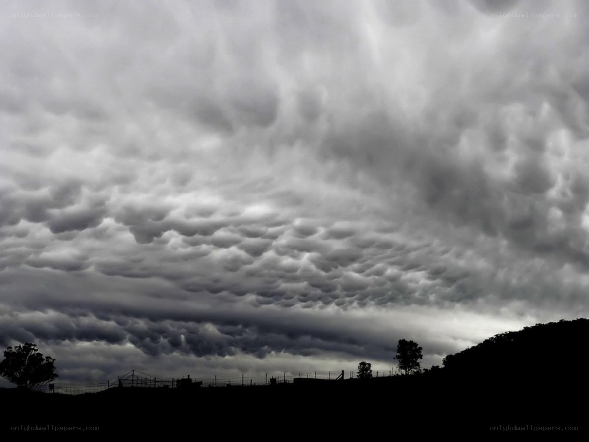 Mammatus clouds over landscape