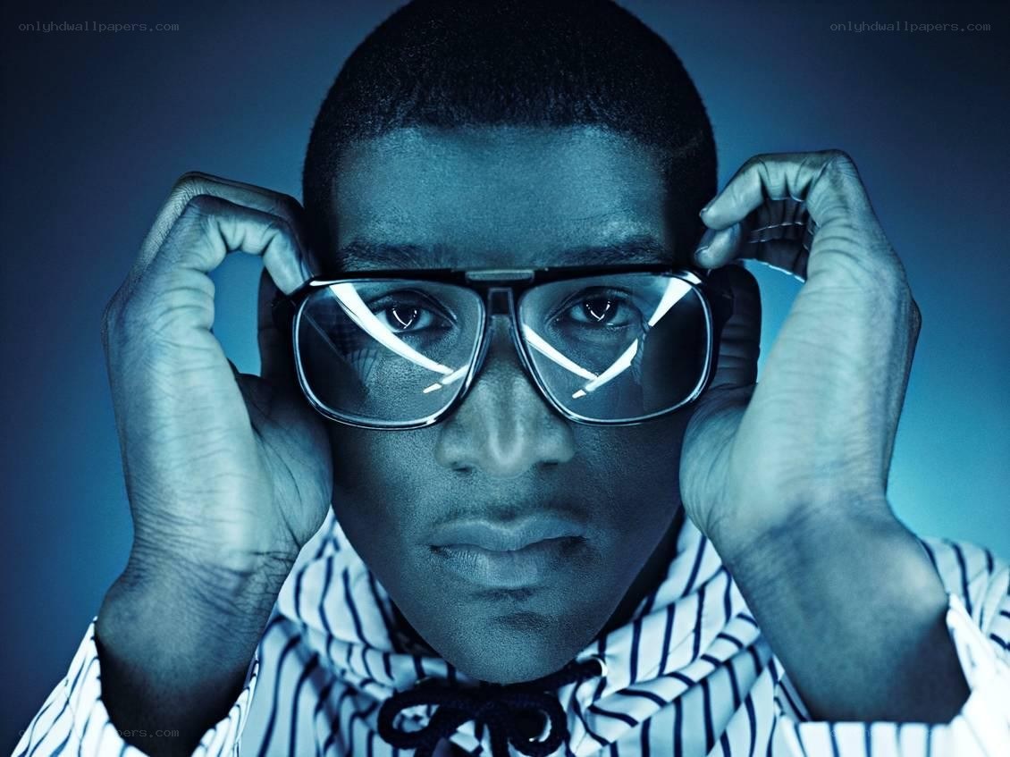 man adjusting glasses in blue light