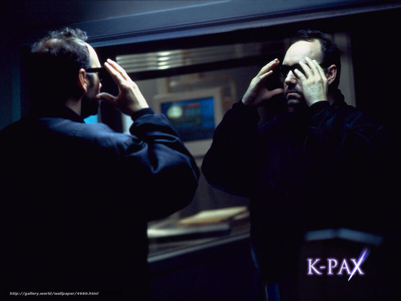 Man adjusting glasses in mirror