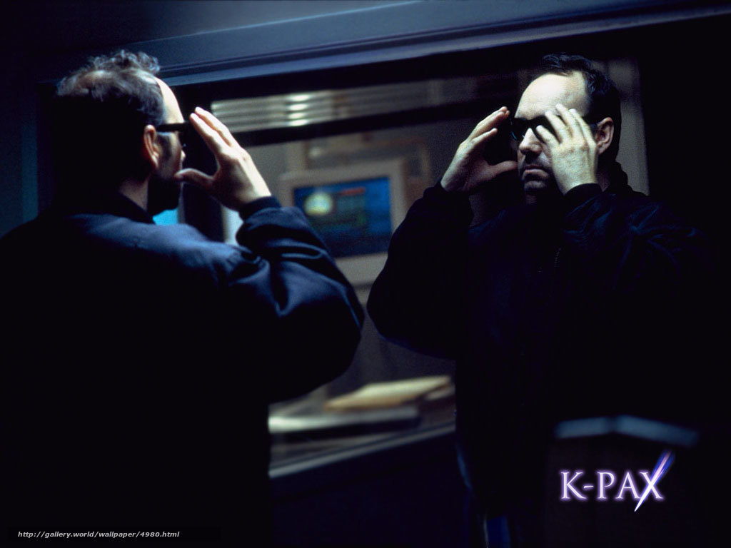Man adjusting glasses in mirror