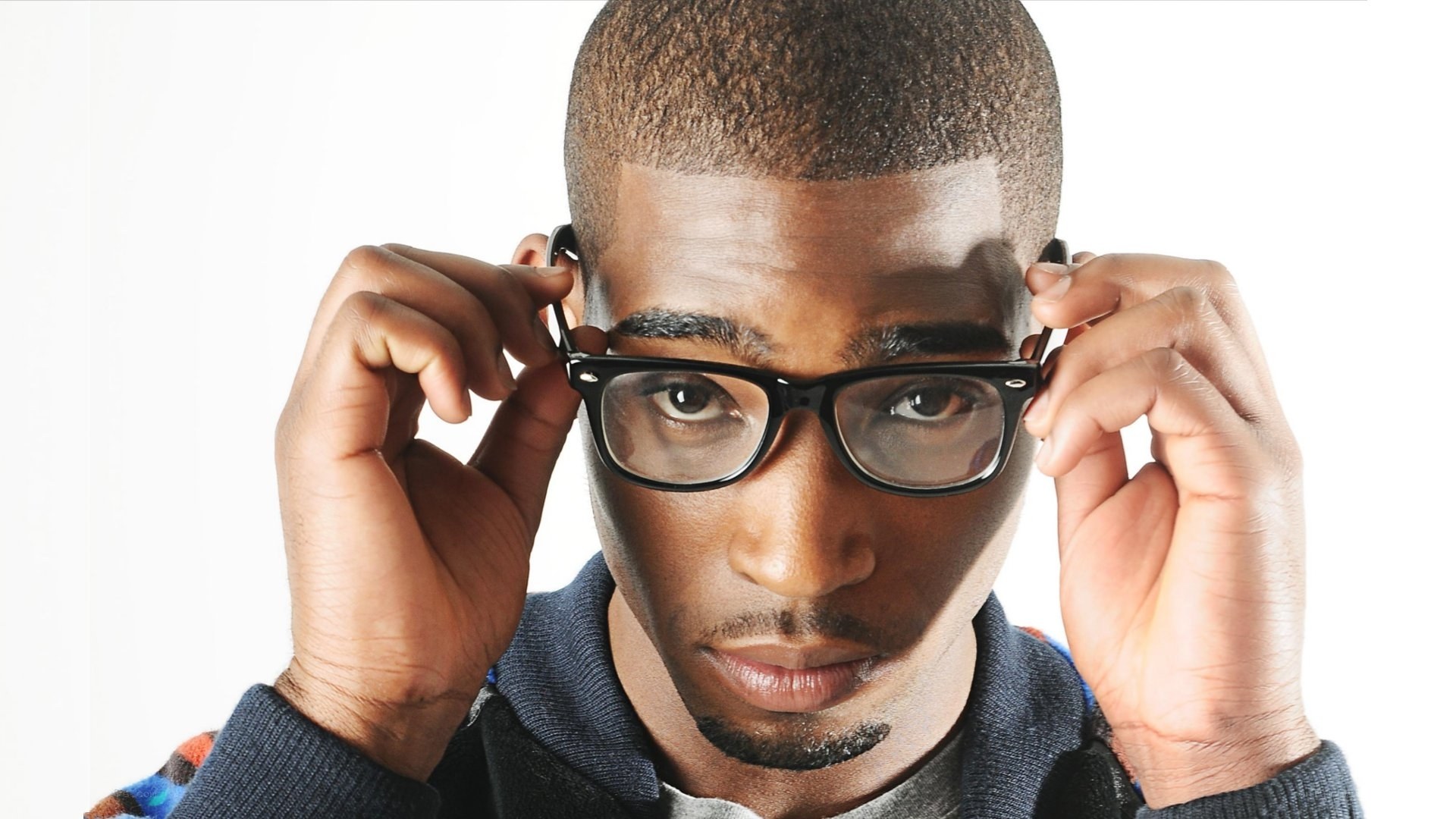 man adjusting glasses