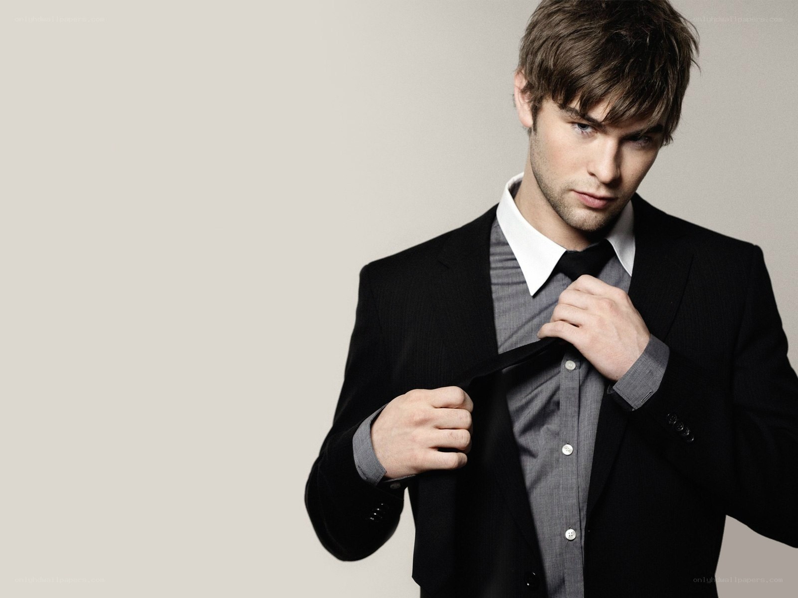 man adjusting his tie