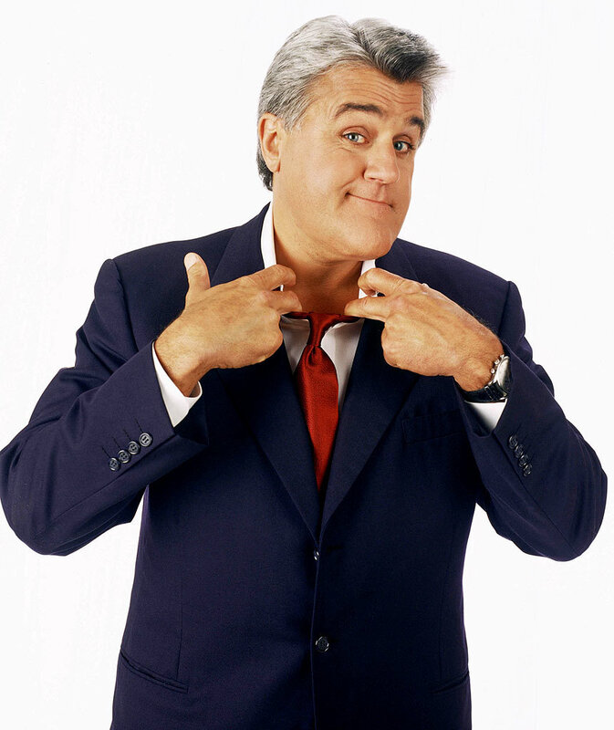 man adjusting his tie