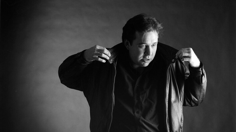 man adjusting leather jacket