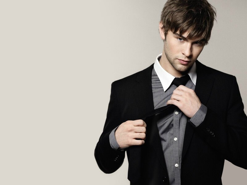 Man Adjusting Tie — Black, Serious