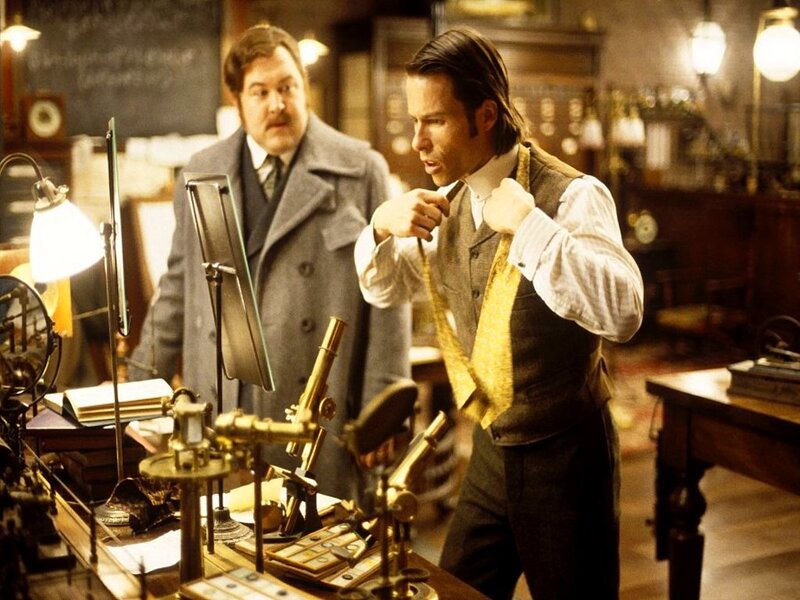 man adjusting tie in lab
